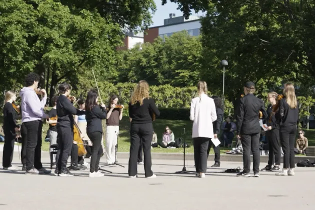 Personer spelar musik i en park. Foto.